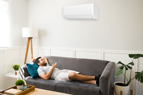 Man relaxing under a heat pump